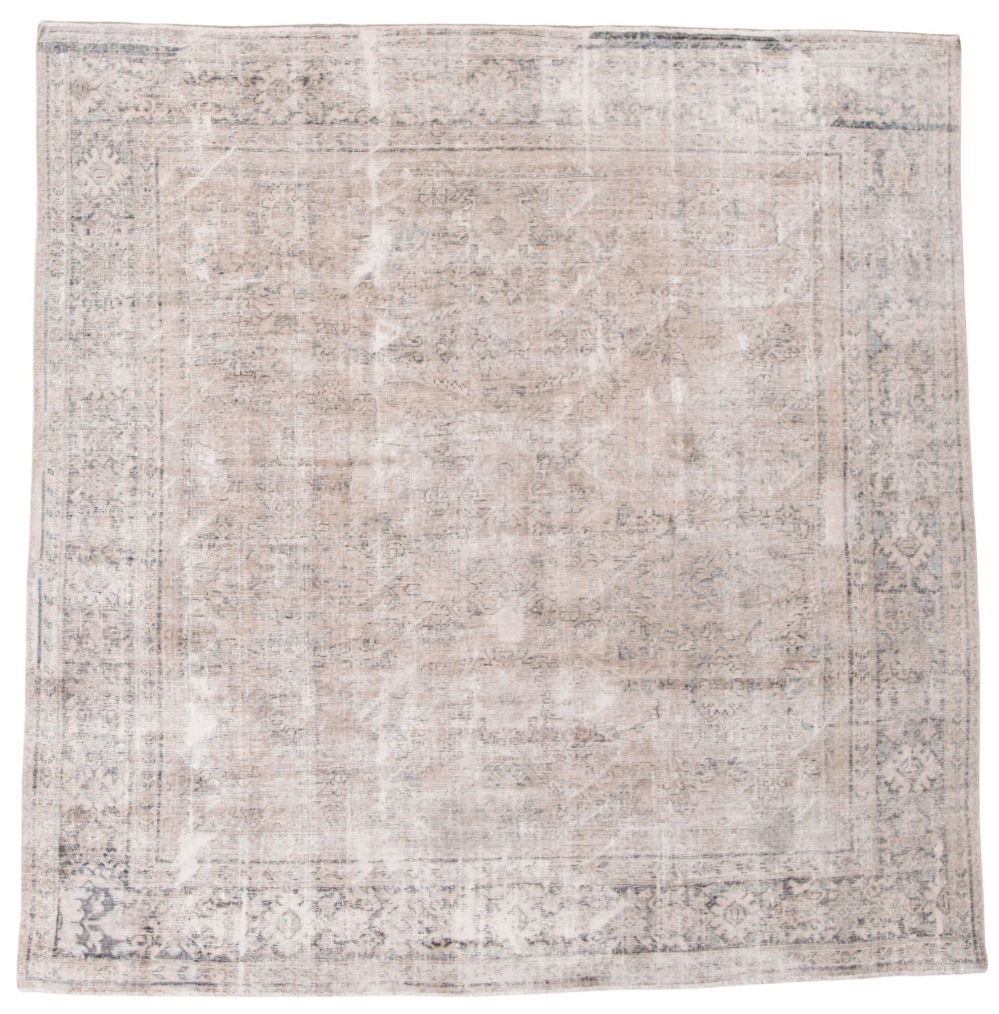 A distressed traditional area rug with an abstract, faded pattern in shades of beige, gray, and off-white, shown flat against a white background.