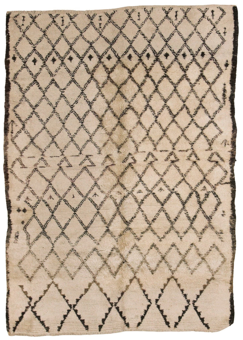 A square beige textile rug or mat with a black diamond lattice pattern and a dark fringe around the edges, photographed flat against a white background.