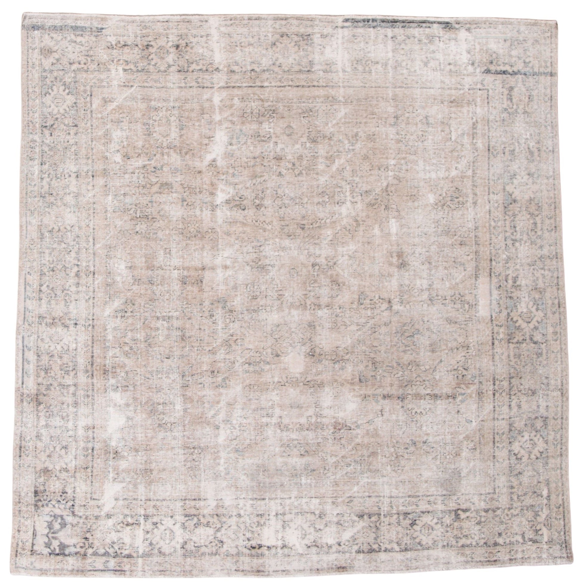 A distressed traditional area rug with an abstract, faded pattern in shades of beige, gray, and off-white, shown flat against a white background.