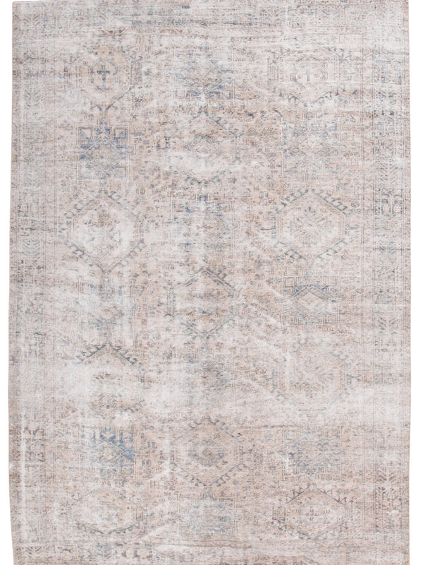 A rectangular area rug with a distressed, vintage-style pattern in soft beige, cream, and muted blue-gray tones.