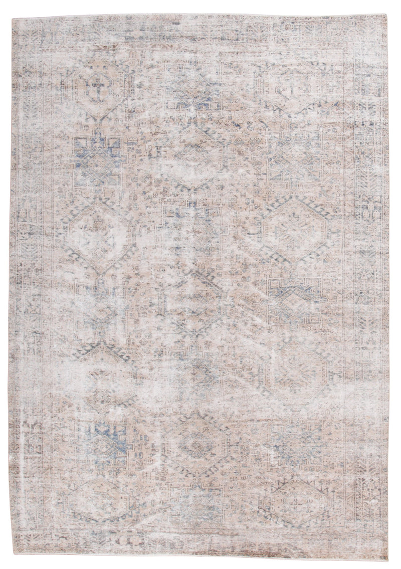 A rectangular area rug with a distressed, vintage-style pattern in soft beige, cream, and muted blue-gray tones.