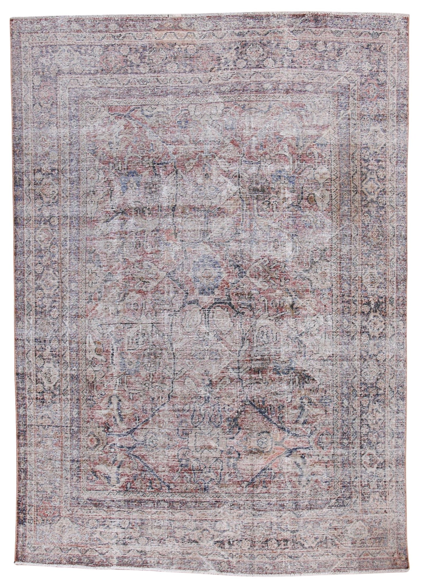 A distressed traditional oriental rug with an intricate floral and medallion pattern in faded dusty pink, beige, and muted blue-gray tones, shown flat against a white background.